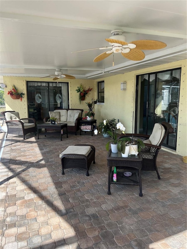 view of patio / terrace with ceiling fan and an outdoor living space