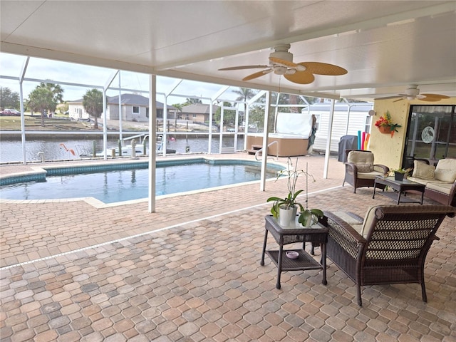 view of swimming pool featuring a water view and a ceiling fan