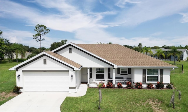 single story home with covered porch, a garage, and a front lawn