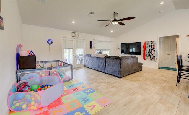 rec room featuring ceiling fan, light wood-type flooring, and vaulted ceiling