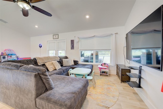 living room with light hardwood / wood-style flooring and ceiling fan