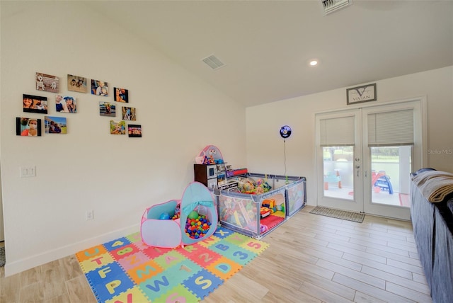 game room with light hardwood / wood-style floors and french doors