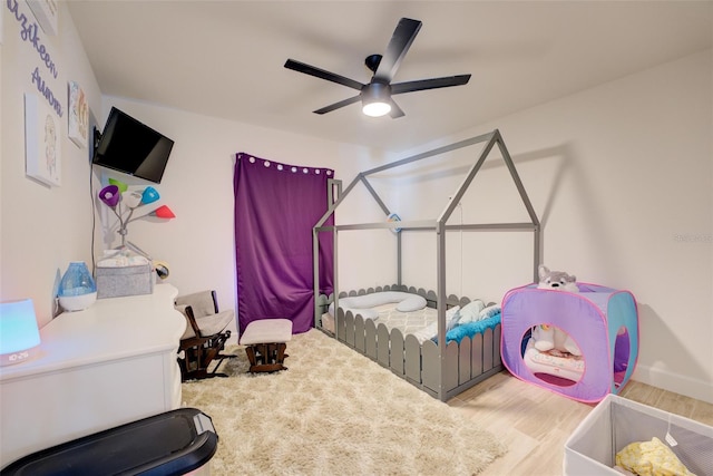 bedroom featuring light wood-type flooring and ceiling fan