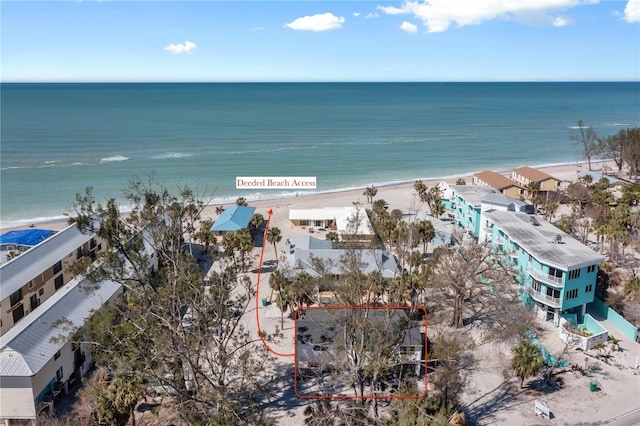 birds eye view of property featuring a beach view and a water view