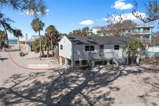 rear view of property with a deck with water view