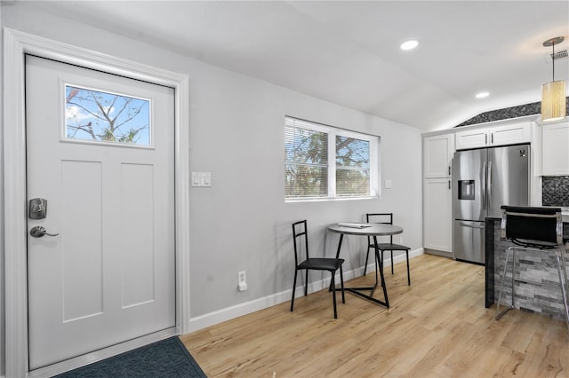 foyer featuring light hardwood / wood-style flooring and lofted ceiling