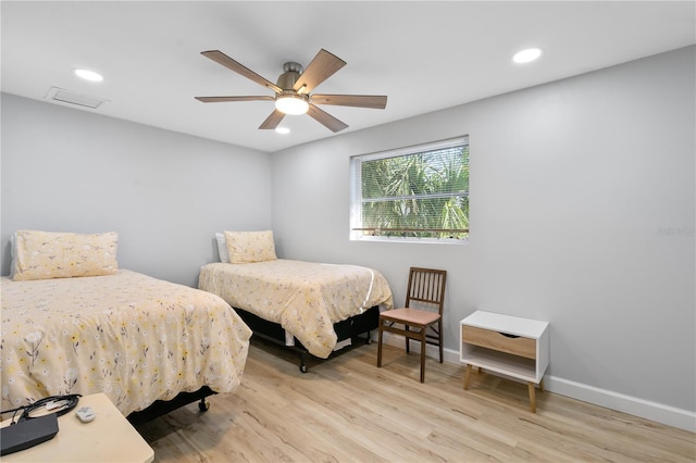 bedroom with ceiling fan and light hardwood / wood-style flooring