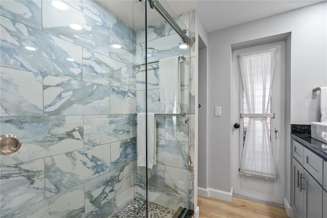 bathroom with vanity, hardwood / wood-style floors, and an enclosed shower