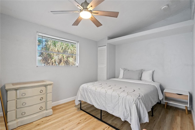 bedroom featuring ceiling fan, a closet, and light hardwood / wood-style floors