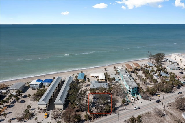 birds eye view of property featuring a beach view and a water view