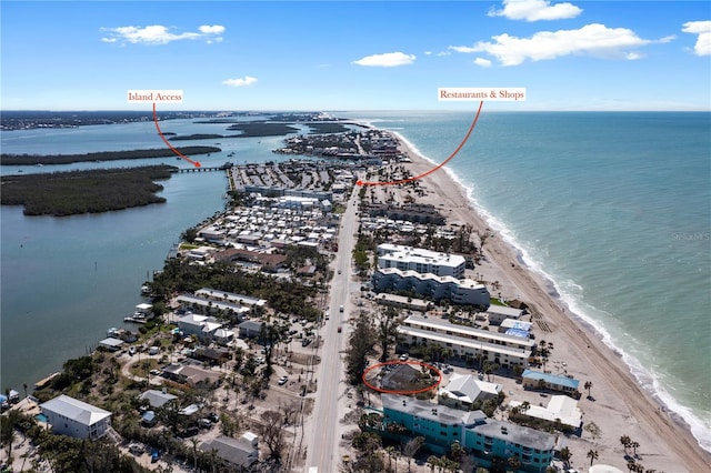 bird's eye view with a water view and a beach view