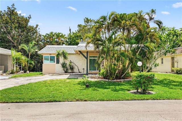 view of front of house featuring a front yard and stucco siding