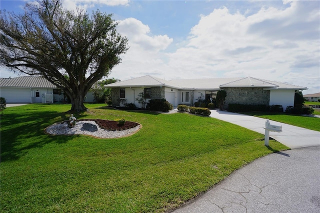 single story home with a front yard and concrete driveway