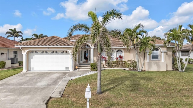 mediterranean / spanish-style home featuring concrete driveway, a front lawn, an attached garage, and stucco siding