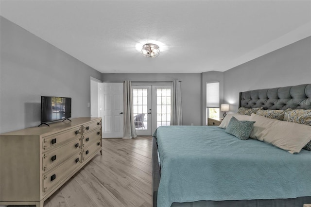 bedroom featuring light wood-style flooring, access to outside, and french doors