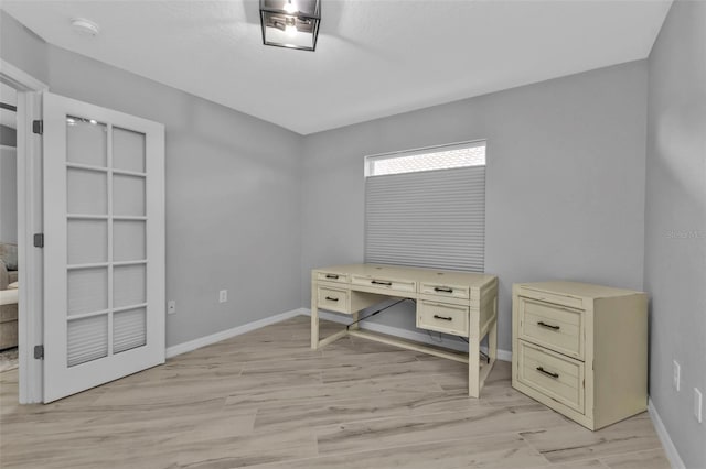 office with light wood-type flooring and baseboards