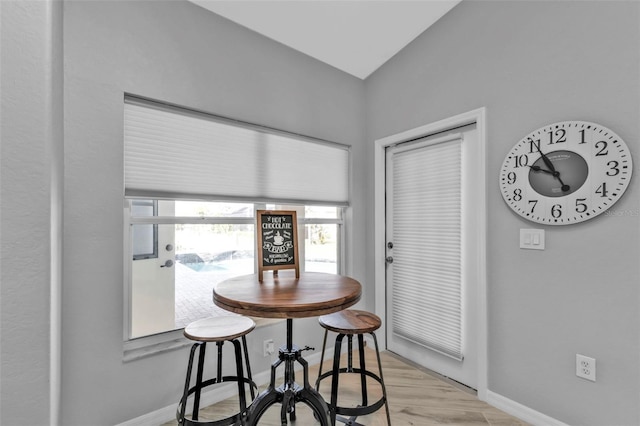 dining area with baseboards and light wood-style floors