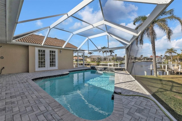 view of swimming pool with a patio, french doors, a water view, and a lanai