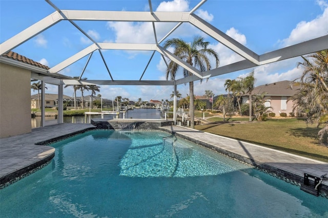 outdoor pool with a lanai, a water view, and a yard