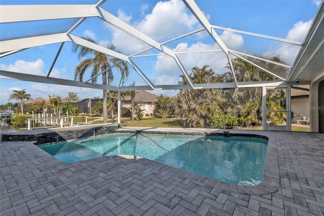 pool with glass enclosure and a patio area