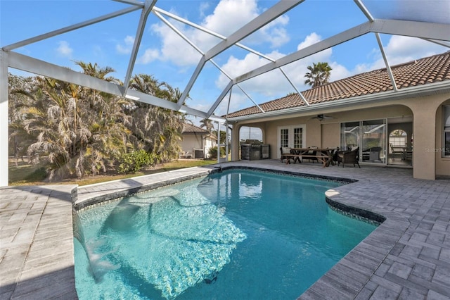 pool featuring french doors, a patio area, a lanai, and a ceiling fan