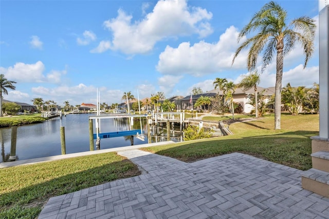 dock area with a yard, a water view, and boat lift