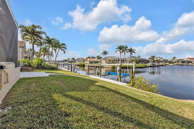 view of dock with a residential view, a lanai, a water view, and a yard