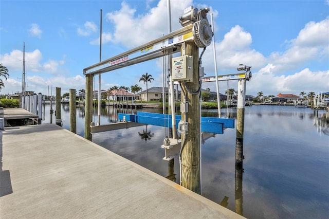 dock area with a water view and boat lift