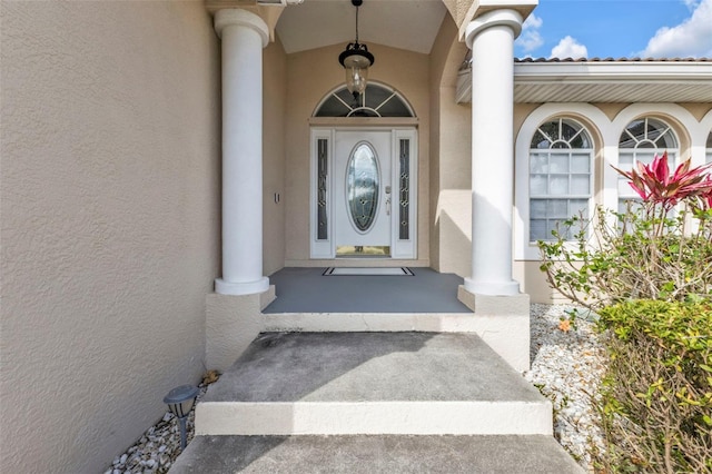 doorway to property with stucco siding