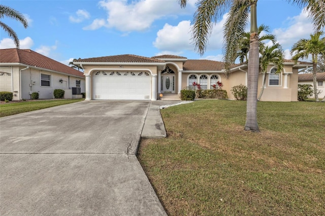 view of front facade with a garage, concrete driveway, a front lawn, and stucco siding