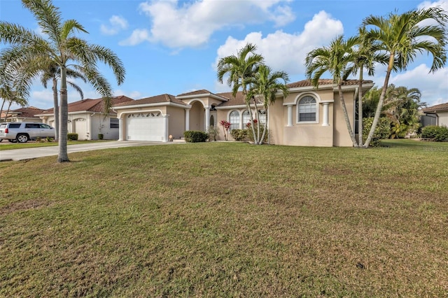 mediterranean / spanish-style house featuring a front yard, driveway, an attached garage, and stucco siding