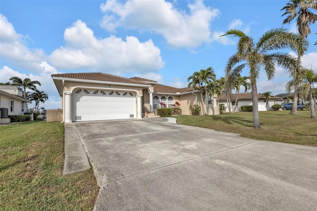 view of front of property with driveway, an attached garage, a front lawn, central AC, and stucco siding