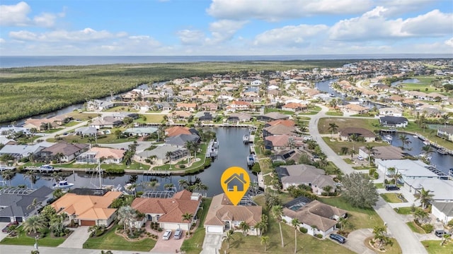 bird's eye view with a water view and a residential view