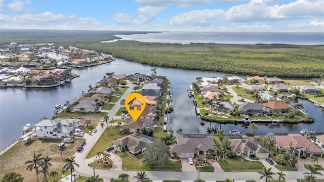 drone / aerial view with a water view and a residential view