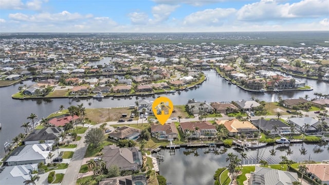 drone / aerial view featuring a water view and a residential view