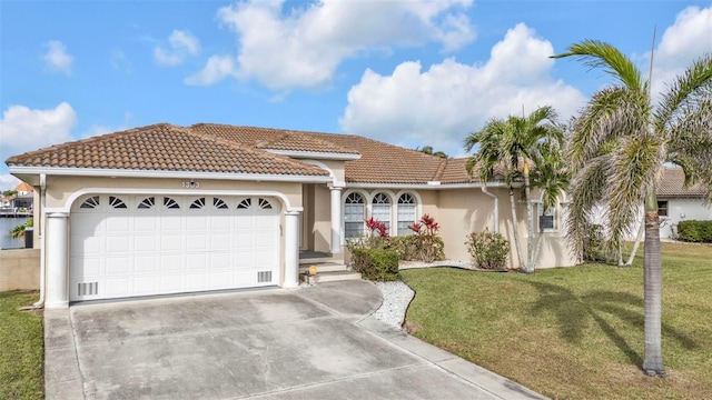 view of front of home with a garage, driveway, a tiled roof, stucco siding, and a front lawn