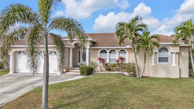 mediterranean / spanish home featuring a garage, concrete driveway, stucco siding, a tile roof, and a front yard