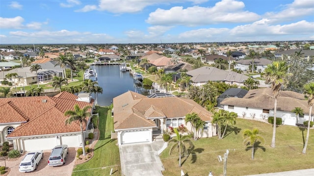 birds eye view of property with a water view and a residential view