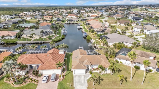 birds eye view of property with a residential view and a water view