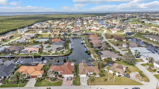 birds eye view of property with a water view and a residential view