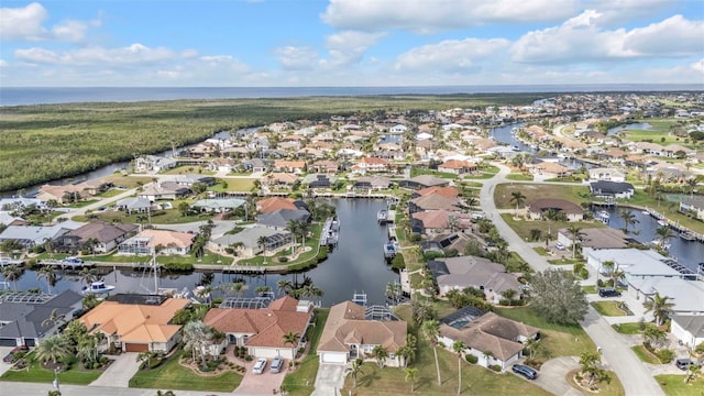 birds eye view of property with a water view and a residential view