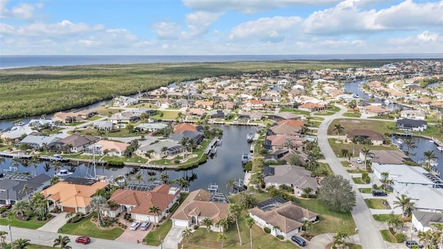 drone / aerial view featuring a water view and a residential view