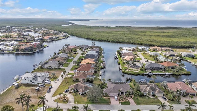 drone / aerial view featuring a water view and a residential view