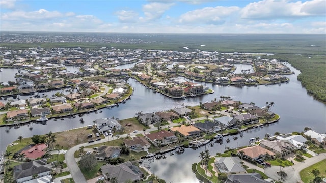 drone / aerial view with a water view and a residential view