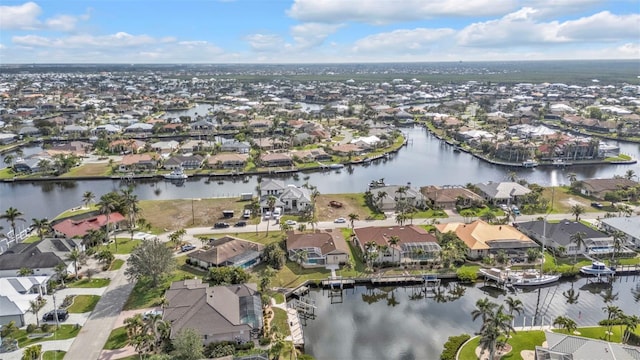 birds eye view of property featuring a water view and a residential view