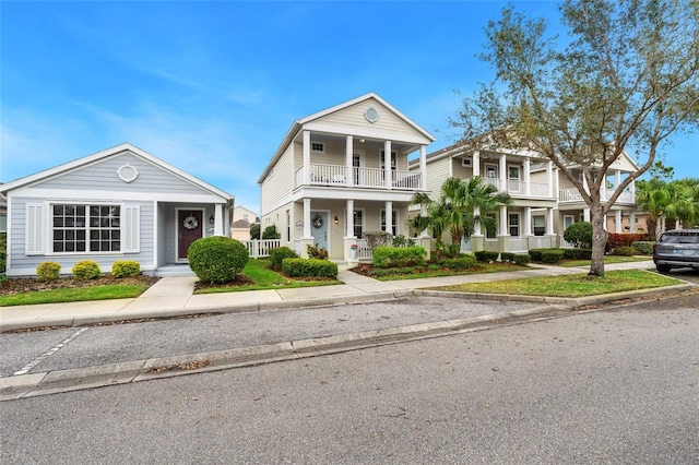 greek revival inspired property with covered porch and a balcony