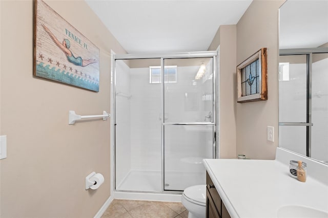 full bath featuring tile patterned flooring, toilet, vanity, baseboards, and a stall shower