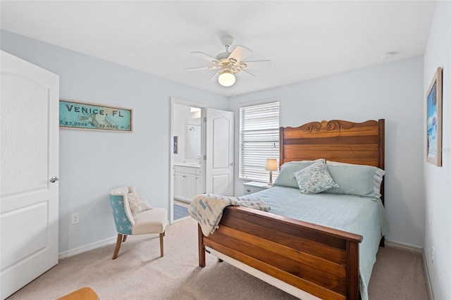 bedroom with light carpet, ensuite bath, ceiling fan, and baseboards