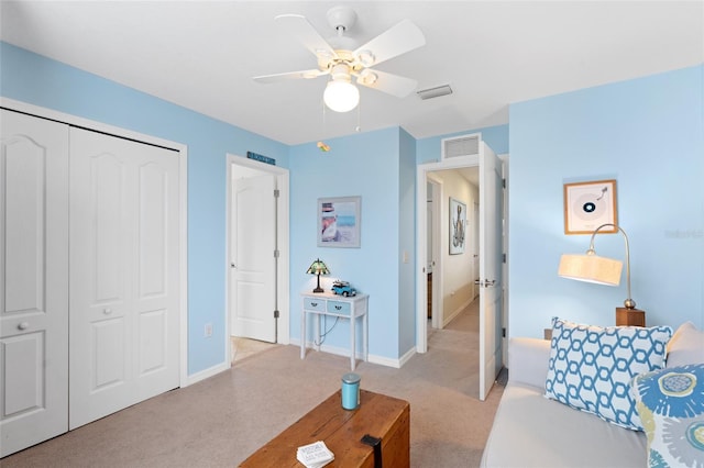 interior space featuring baseboards, visible vents, a closet, and light colored carpet