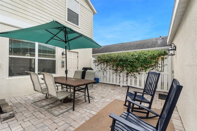 view of patio / terrace featuring outdoor dining area and fence